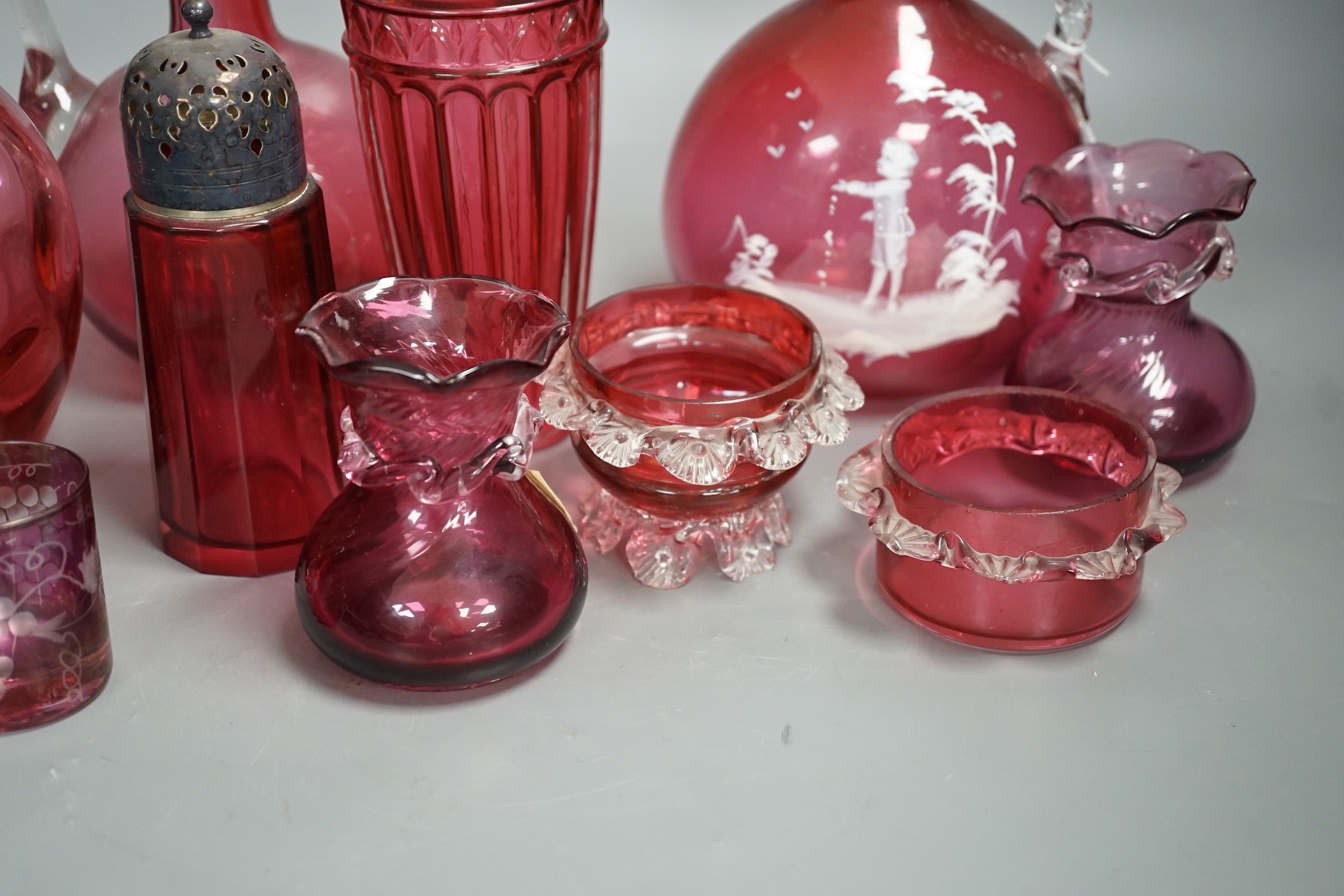 A Mary Gregory style cranberry decanter together with mixed cranberry glass (10), Mary Gregory decanter 25cms high including stopper